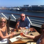 PerryGolf staff take a short lunch break at Azamara Quest's delightful Windows café at the aft of the ship, overlooking the former Royal Yacht Britannia at her berth in Edinburgh.